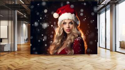 Beautiful young woman in Santa Claus hat. 	
Fashionable young woman in winter clothes over snowy background. Winter background. Wall mural