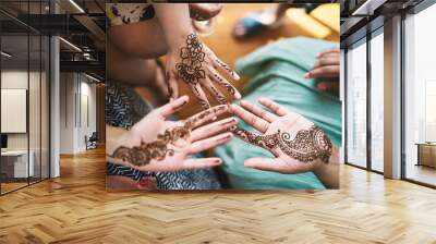 Indian women showing hand with henna tattoo art (Mehndi) Wall mural