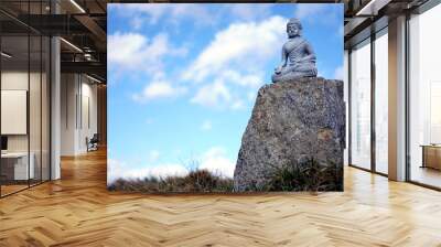 Buddha Sculpture at a Stone in Nature Wall mural