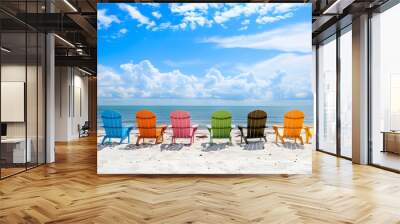 Colorful beach chairs on the white sand at the ocean on a sunny day. A beautiful summer vacation background in the style of copy space for text or design Wall mural