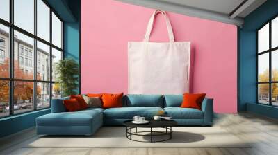 A white bag is sitting on a pink background Wall mural