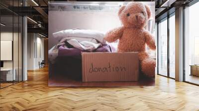 Clothes, books, teddy bears for donations. Social donation concept. Wall mural