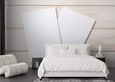 Two white sheets of paper are sitting on a wooden table Wall mural