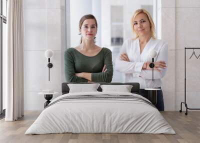 business team of two young female professionals. successful young business women posing with arms cr Wall mural