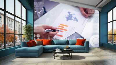 Businessman reading sale report with virtual statistic graphics. Hands of male manager working with marketing papers. Marketing concept Wall mural