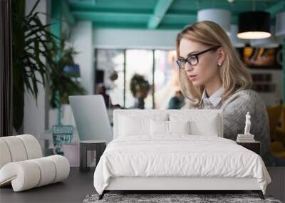 Busy female student preparing for exam in cafe Wall mural