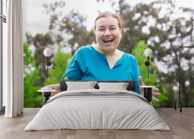 Cheerful plus sized lady having fun in park. Happy excited Caucasian woman in casual gesturing and smiling at camera. Positive emotion concept Wall mural