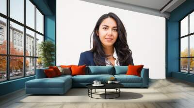 Confident young businesswoman. Portrait of beautiful young brunette businesswoman smiling at camera isolated on grey background. Emotion concept Wall mural