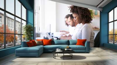 Focused users testing VR software. Man and women in casual sitting at table with virtual reality glasses and using laptops. VR product concept Wall mural