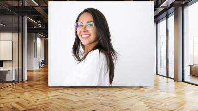 Happy cheerful professional posing in studio. Beautiful young Latin woman in white shirt and stylish eyeglasses smiling at camera. Female portrait concept Wall mural