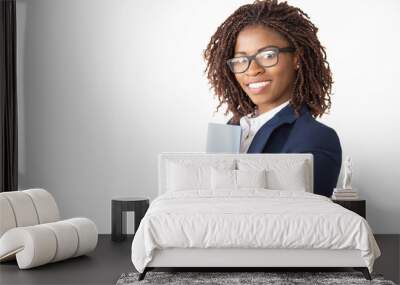 Happy confident legal expert in glasses holding documents, looking at camera, smiling. Young African American business woman posing isolated over white background. Female professional portrait concept Wall mural