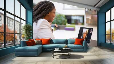 Happy female office friends talking through video call. Business women using digital devices for video chat. Internet connection concept Wall mural