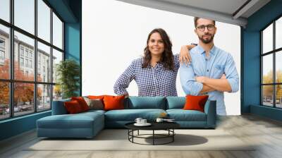 Happy friendly family couple posing together, smiling at camera. Young woman in casual and man in glasses standing isolated over white background. Love and relationship concept Wall mural