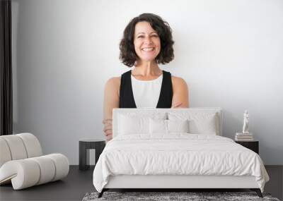 Happy joyful woman in casual posing over white studio background. Portrait of cheerful successful middle aged business lady with arms folded smiling at camera. Female portrait concept Wall mural