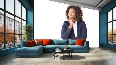 Happy pensive female agent looking at copy space away. Young African American business woman standing isolated over white background, leaning chin on hand, smiling. Advertising concept Wall mural