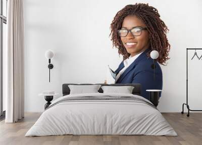 Happy positive professional holding financial reports. Young African American business woman standing isolated over white background. Employee with documents concept Wall mural