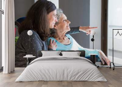 Happy senior mother and adult daughter enjoying dramatic view Wall mural