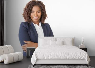 Happy successful female consultant looking at camera. Young African American business woman with arms crossed standing isolated over white background, smiling. Corporate portrait concept Wall mural