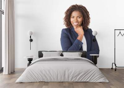 Happy successful female professional looking at camera. Young African American business woman standing isolated over white background, leaning chin on hand, smiling. Confident business lady concept Wall mural