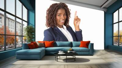 Joyful young professional having new idea, pointing index finger up. African American business woman standing isolated over white background, looking at camera, smiling. Advertising concept Wall mural