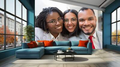 Multiethnic business colleagues smiling at camera. Portrait of happy young business people smiling at camera together. Cooperation concept Wall mural