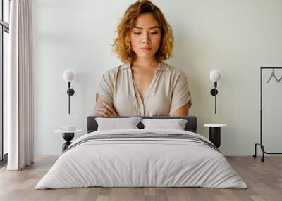 Portrait of upset young Asian woman in studio Wall mural