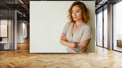 Portrait of worried young woman standing in studio Wall mural