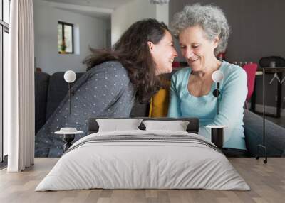 Positive elderly woman and her daughter having fun Wall mural