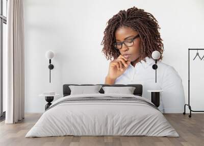 Serious focused manager watching presentation on tablet. Young African American female professional standing isolated over white background. Digital device using concept Wall mural