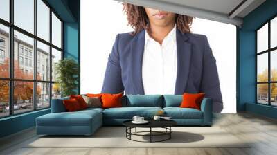 Serious successful female professional posing with clasped hands. Young African American business woman standing isolated over white background, looking at camera. Corporate portrait concept Wall mural