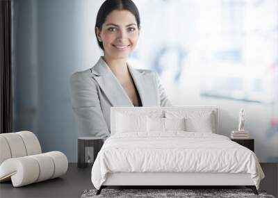 Smiling Pretty Business Woman With Arms Crossed Wall mural