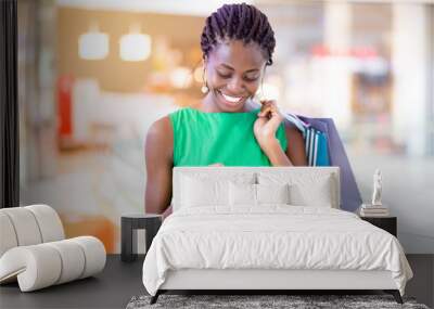 smiling woman texting message in shopping mall Wall mural