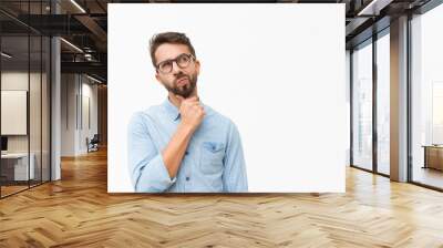 Thoughtful male customer thinking hard, looking away at copy space, leaning chin on hand. Handsome young man in casual shirt and glasses standing isolated over white background. Special offer concept Wall mural