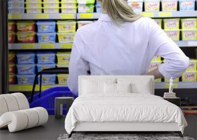 costumer shopping in the supermarket choosing a product Wall mural