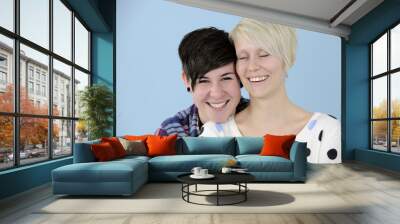 portrait of a lesbian couple on blue background Wall mural