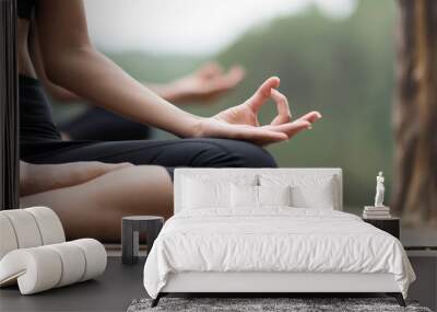 close up hand and soft focus of young people do yoga near the lake Wall mural