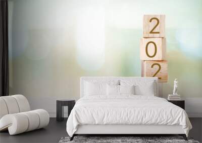 2024 new year greeting card, wooden cubes with 2024 on wood table over blur bokeh background with copy space for text, new year template Wall mural