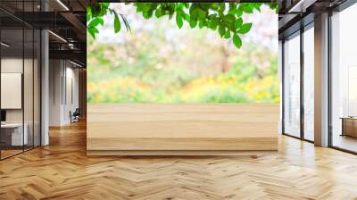 Empty wooden table over blurred tree with bokeh background, for product display montage Wall mural