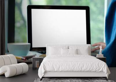 Woman hands typing laptop computer with blank screen for mock up while sitting by the window, technology and lifestyle concept Wall mural