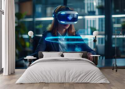 Attractive business woman sitting at an office desk wearing a VR headset, floating hologram icons in front. Wall mural