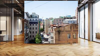 Downtown backyard with old buildings rooftops in a sunny summer day Wall mural