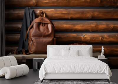 A leather travel backpack and its essentials are showcased against a backdrop of rustic wooden wall. Wall mural