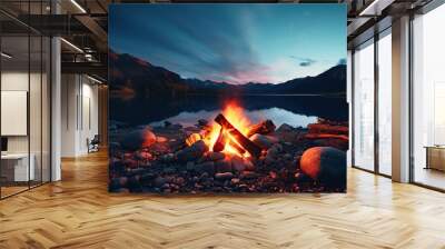 A serene lake valley serves as the backdrop for a campfire. Wall mural