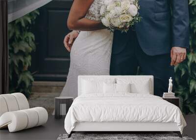 Afro-american bride and caucasian groom posing on a wedding photo shoot Wall mural