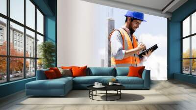 A portrait of an industrial man engineer with smartphone in a factory, working. Wall mural