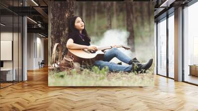 Asia woman playing the guitar with loneliness and sadness.heartbroken woman concept. Wall mural