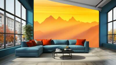 A solitary hiker stands on a mountain peak as the sun rises, casting golden light over the majestic landscape. Wall mural