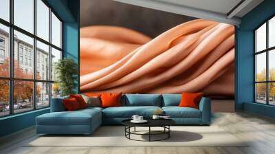 Delicate wave of soft peach fabric gracefully draped, creating a sense of elegance and tranquility for interior decor or fashion. Wall mural