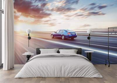 Dynamic Blue Sedan Speeding on Highway at Sunset with Blurred Motion, Illuminated by Setting Sun Wall mural