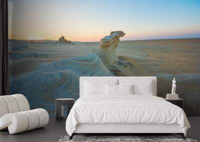 Desert eroded rock pattern with clear sky during the sunset. Desert rock formation with erosion. Wall mural